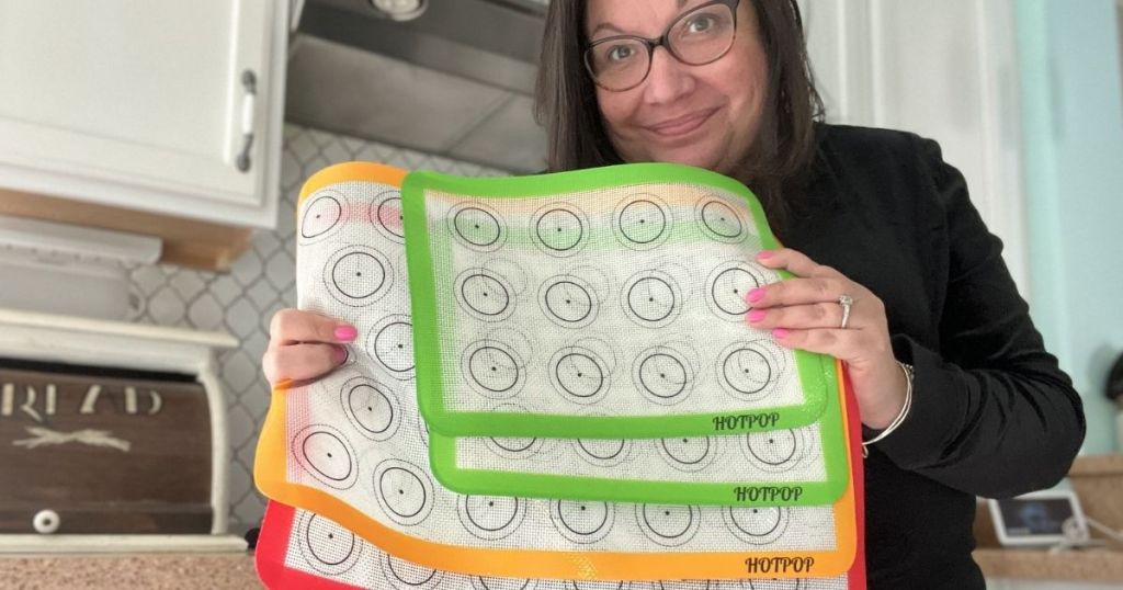 woman holding silicone baking mats