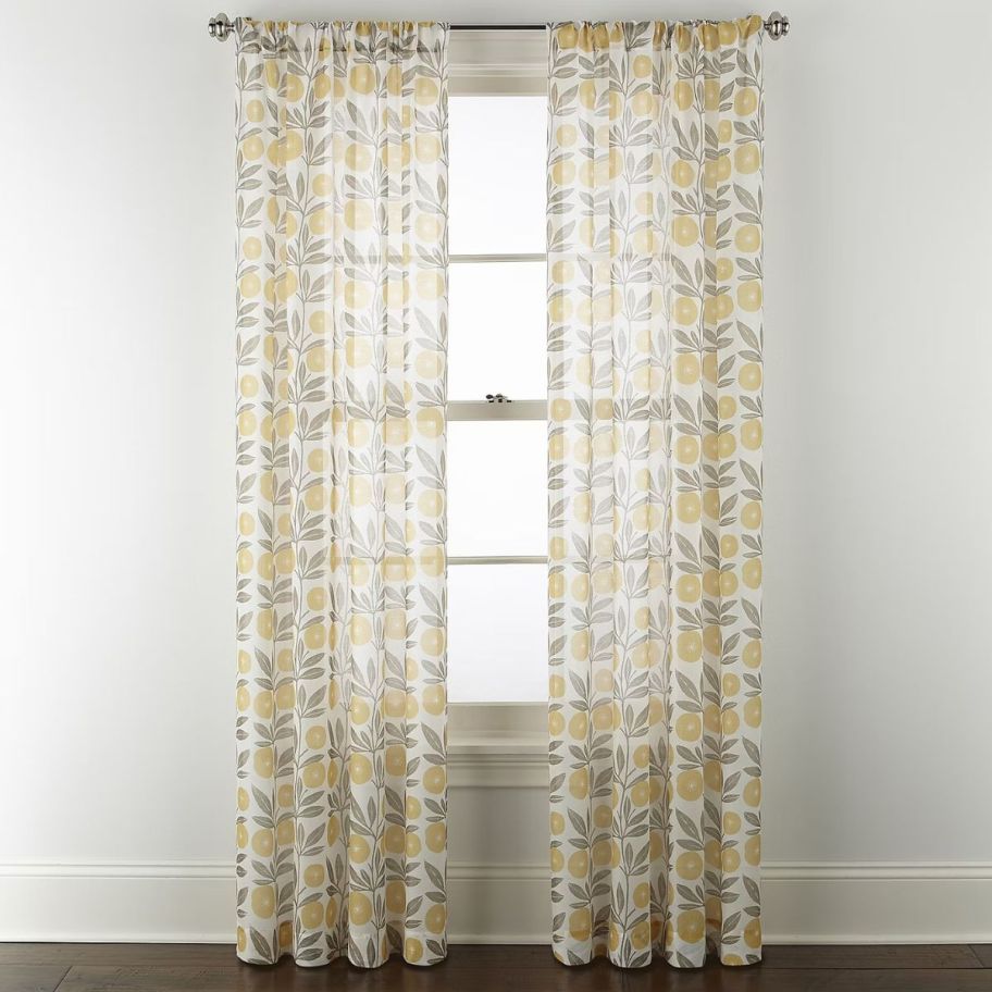 2 sheer curtain panels on a window