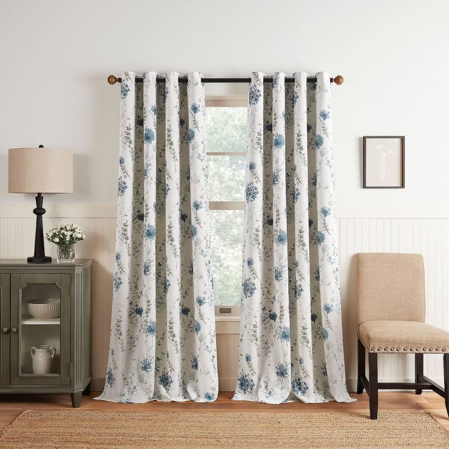 2 floral print curtain panels on a window
