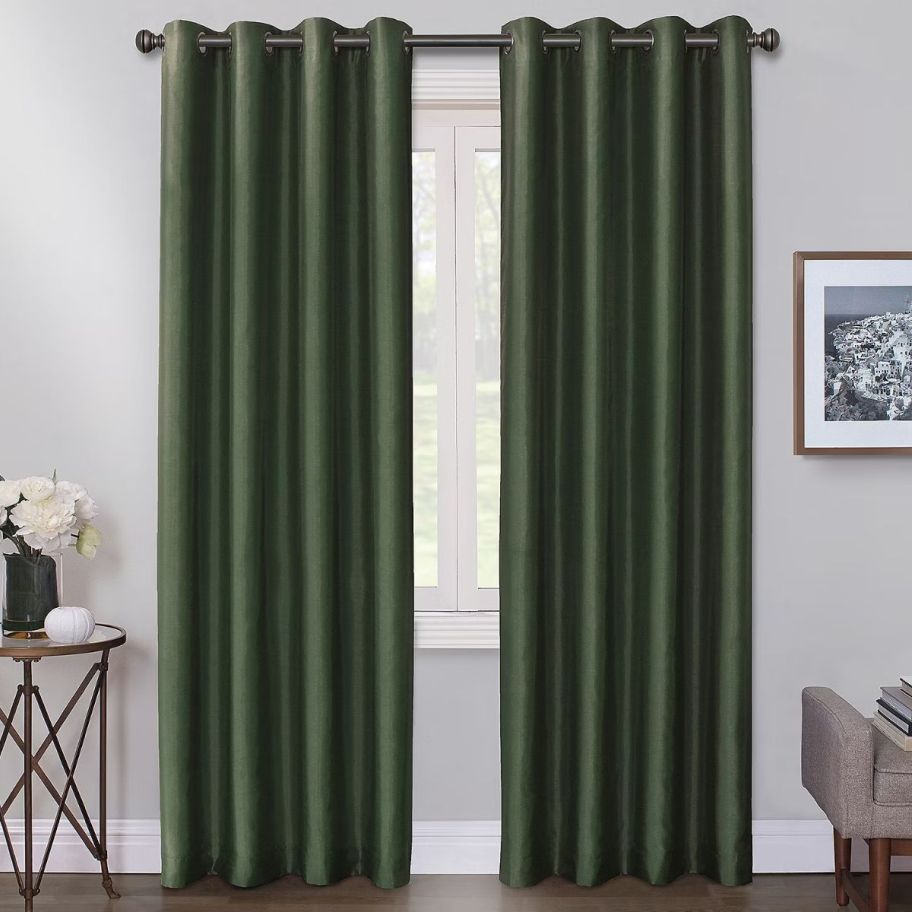 2 dark green curtain panels on a window