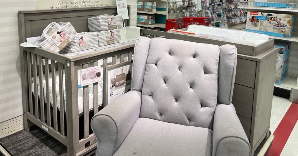 crib, chair and changing table in store on display 