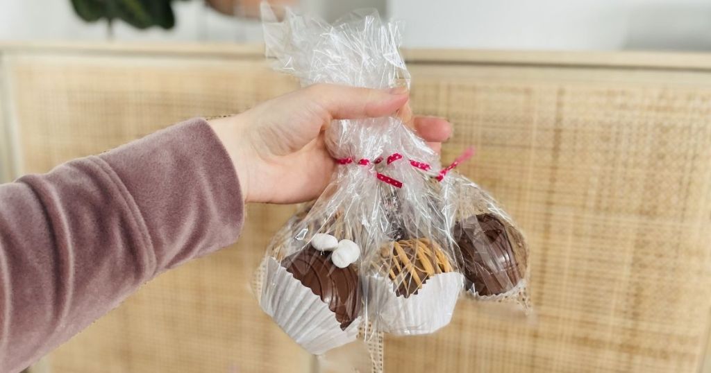 woman holding Cellophane Bags containg chocolate treats