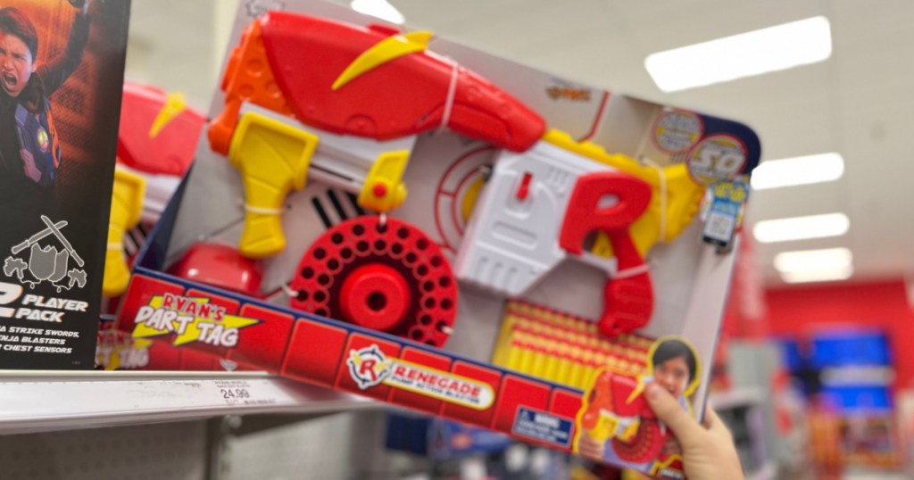 hand grabbing toy dart gun off shelf 