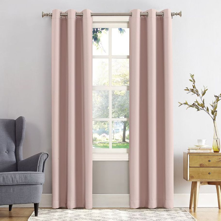 2 pale pink curtain panels on a window