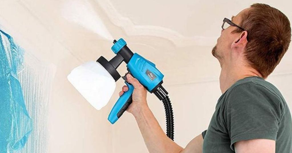 man using a paint sprayer