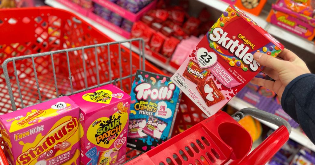 hand grabbing box of valentine's candy cards out of red cart