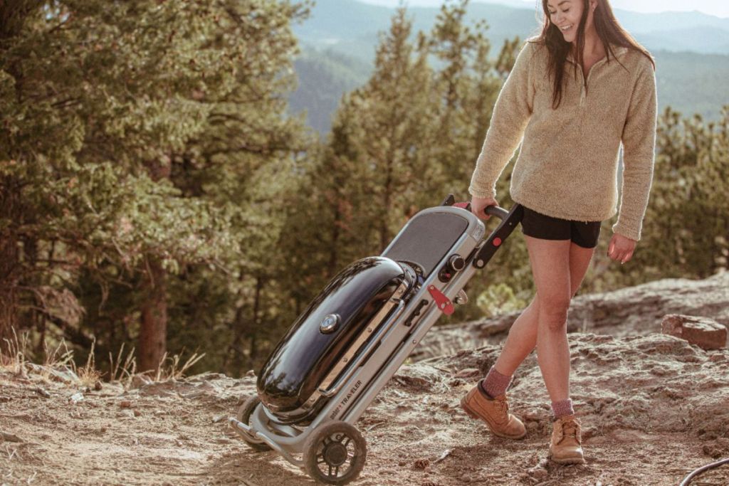 woman pulling a foldable grill