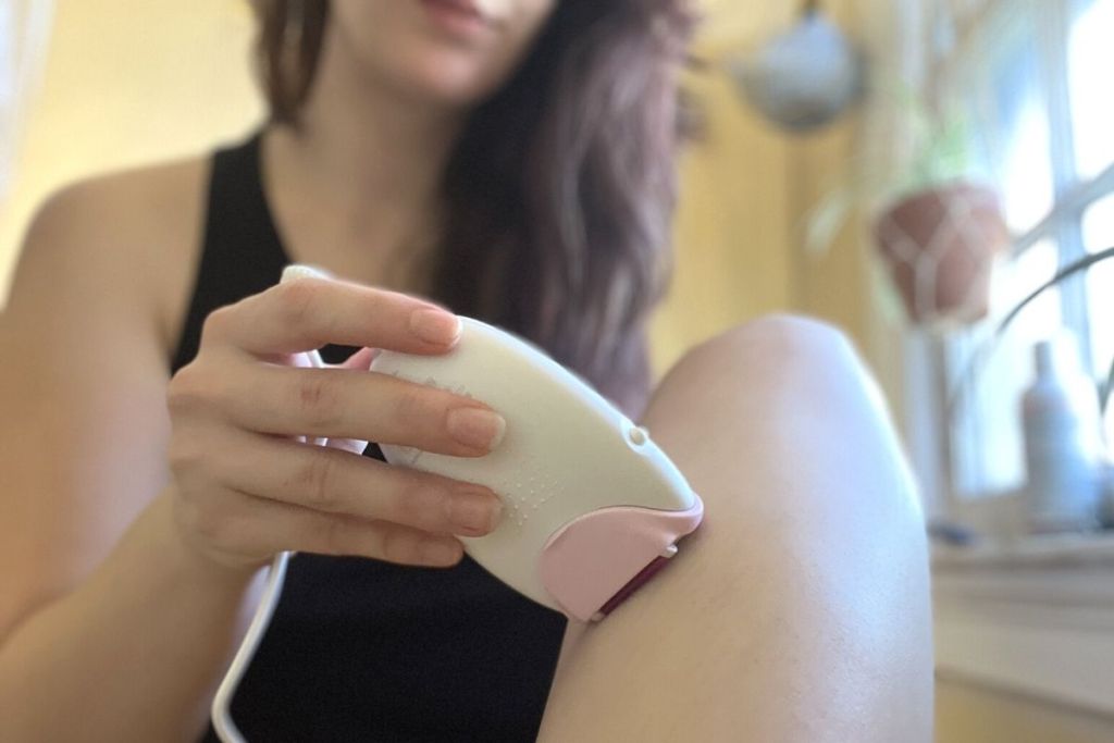 woman using Braun epilator on leg