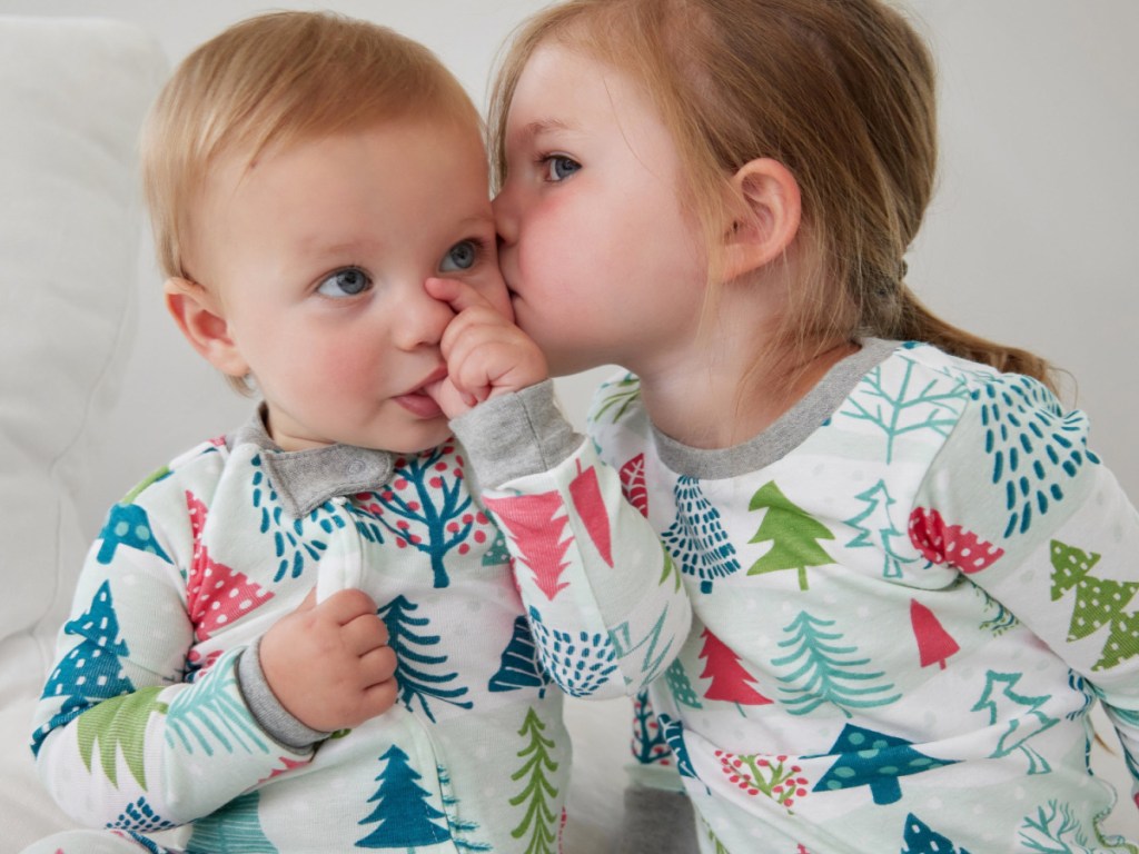 toddler kissing baby on cheek