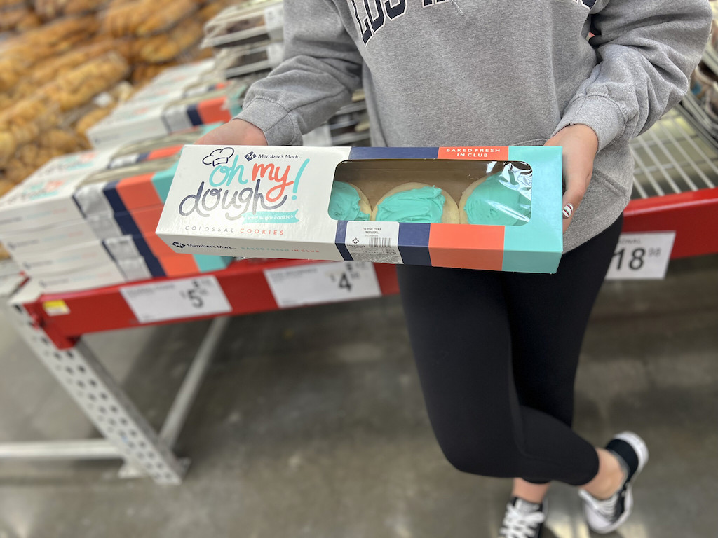 holding large packages of frosted cookies in Sam's Club 
