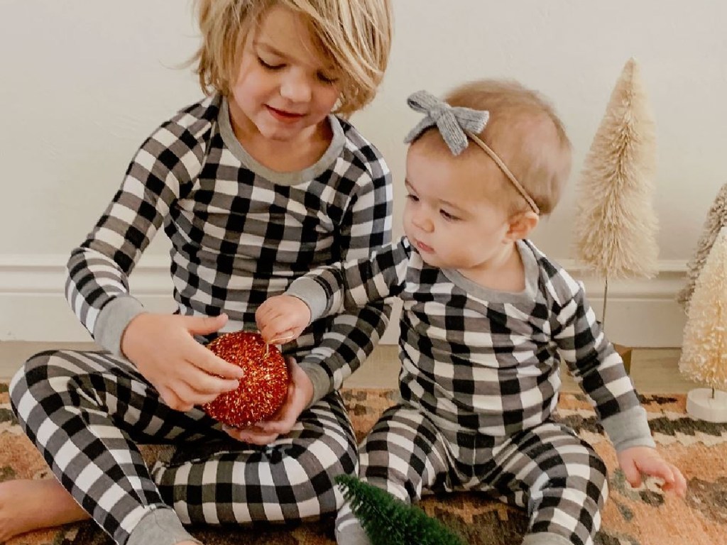 2 kids playing with holiday decorations together