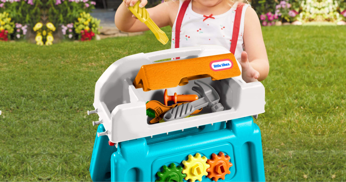 girl playing with pretend tool bench