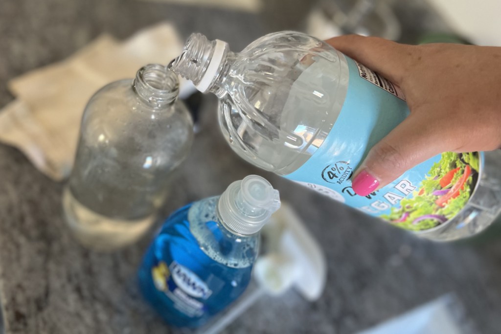 pouring vinegar in spray bottle - how not to clean a Shark vacuum