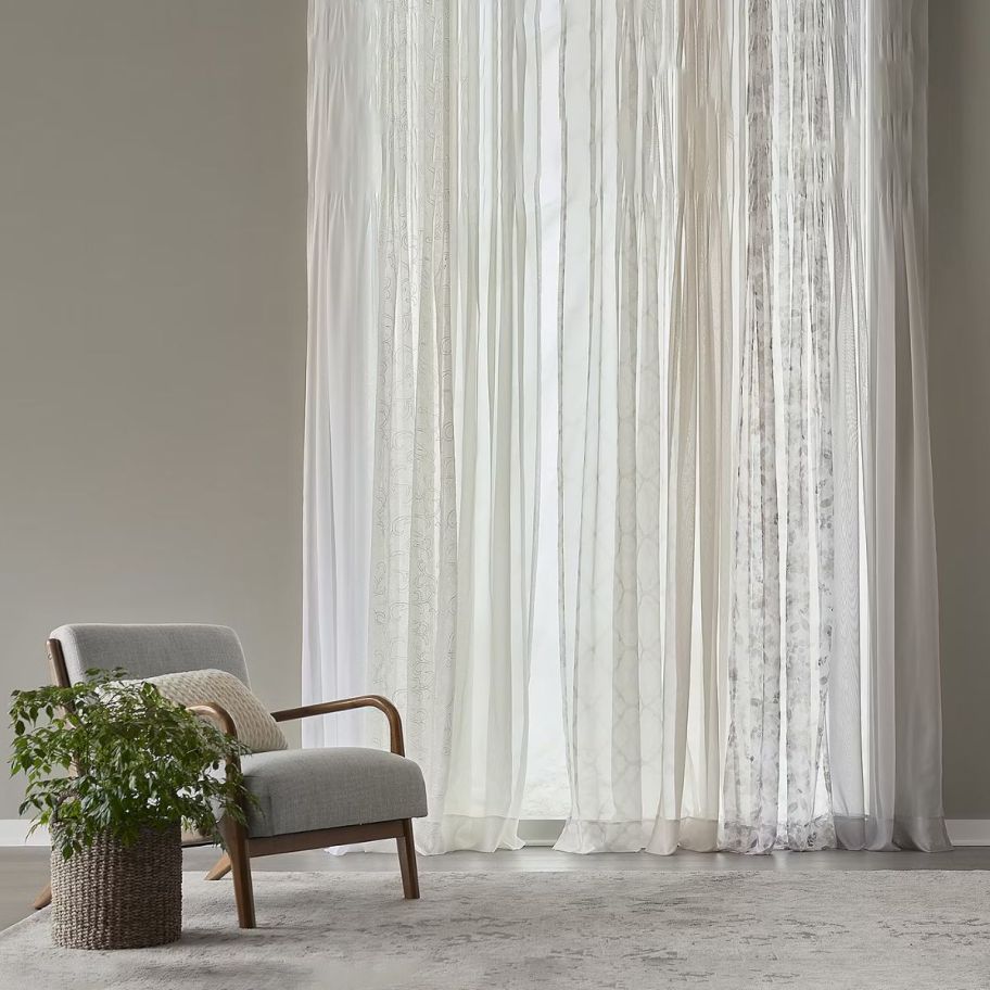 various colored sheer curtains covering a living room window