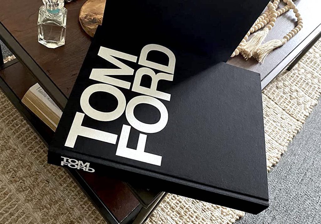 tom ford black and white book sitting on wood coffee table