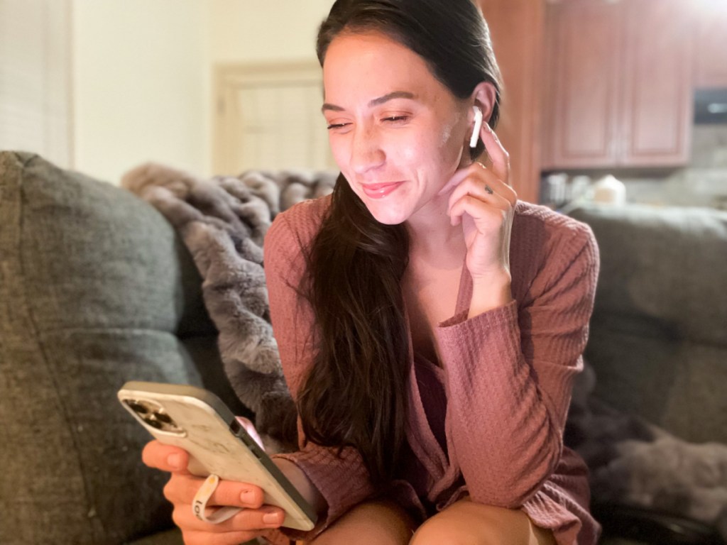 woman with earbud listening to audibook