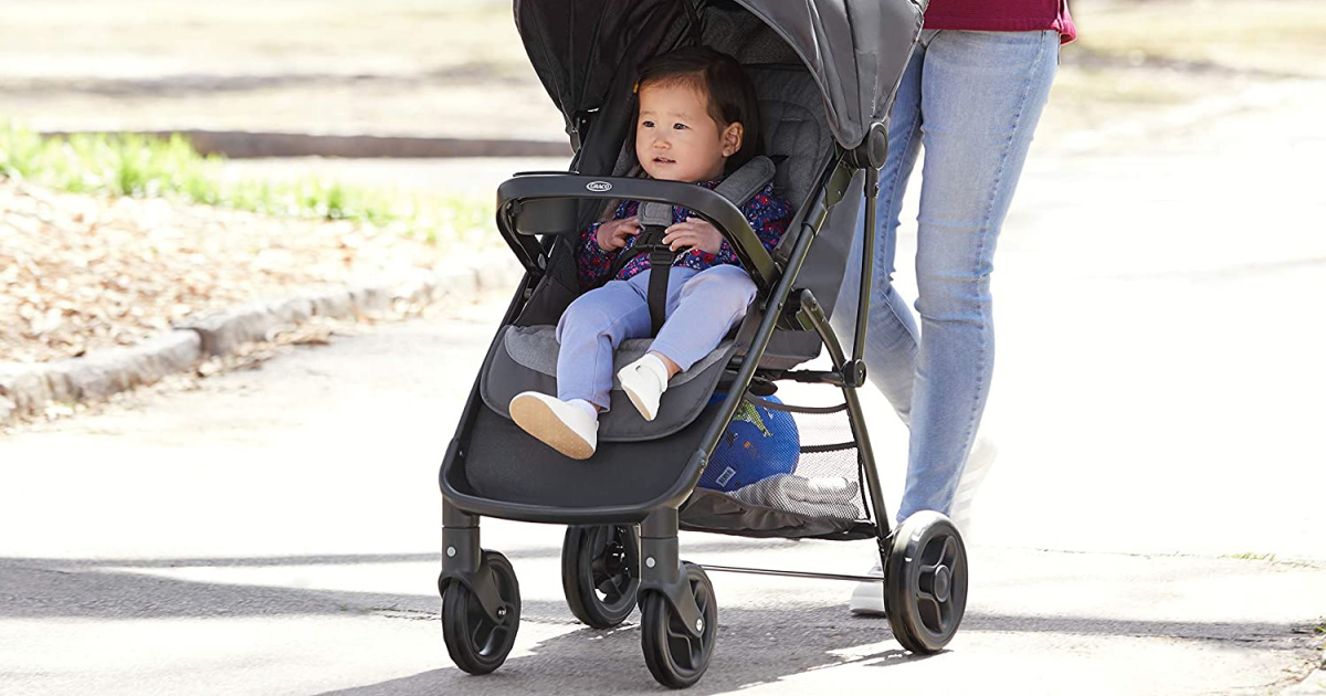 mom pushing baby in black stroller