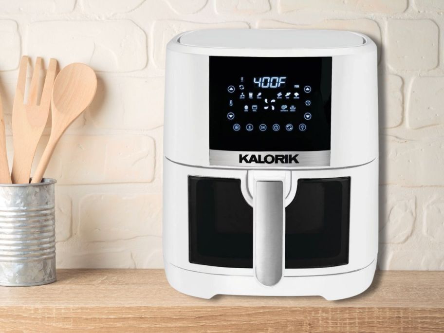 white air fryer with window and display sitting on kitchen counter