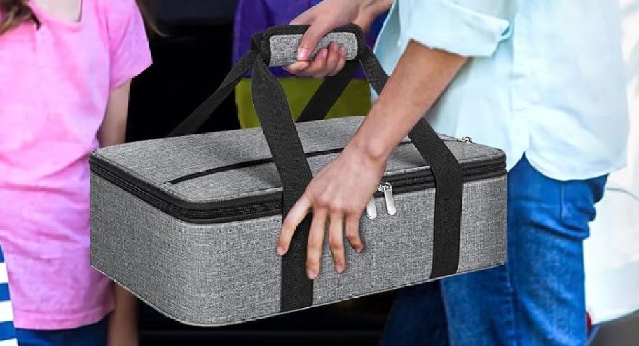 hand holding a casserole carrier