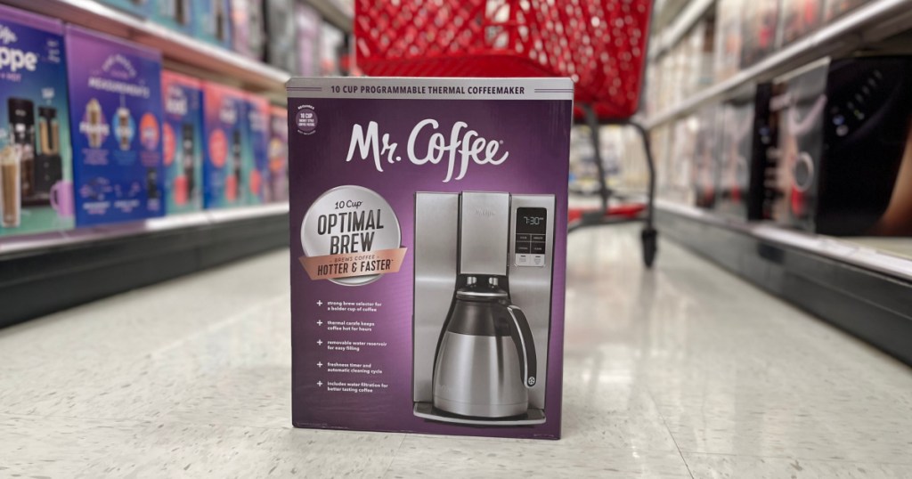 stainless steel coffee maker in pruple box on floor