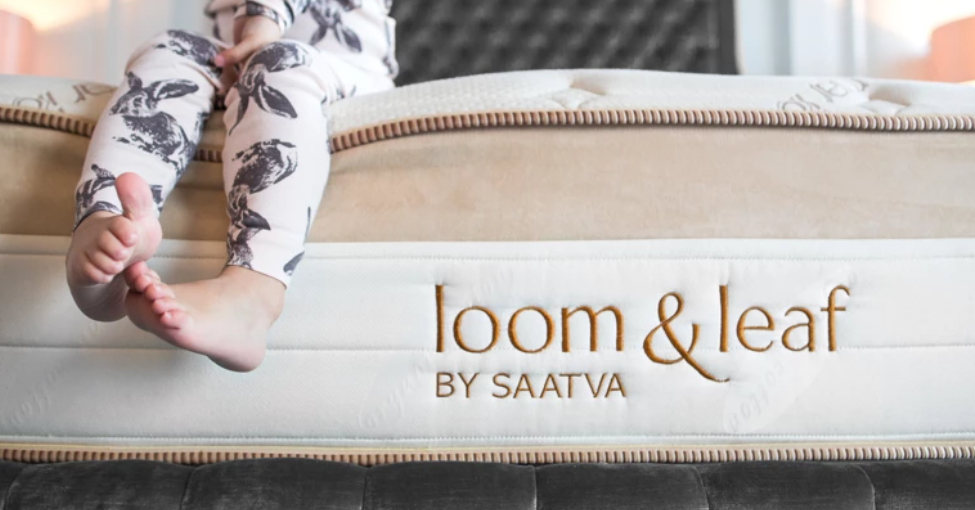 kid sitting on a mattress