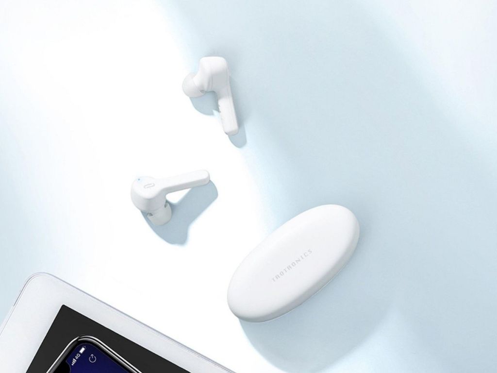white earbuds next to white Taotronics earbuds case