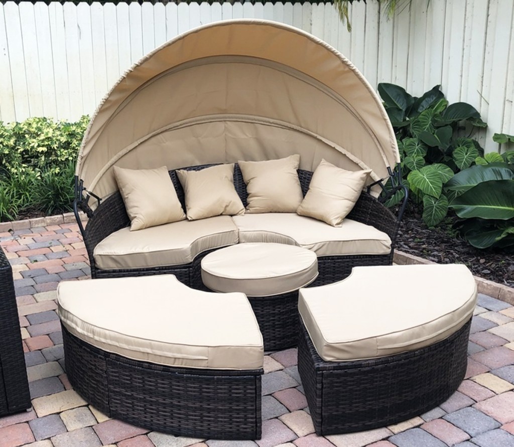 tan wicker daybed with beige cushions