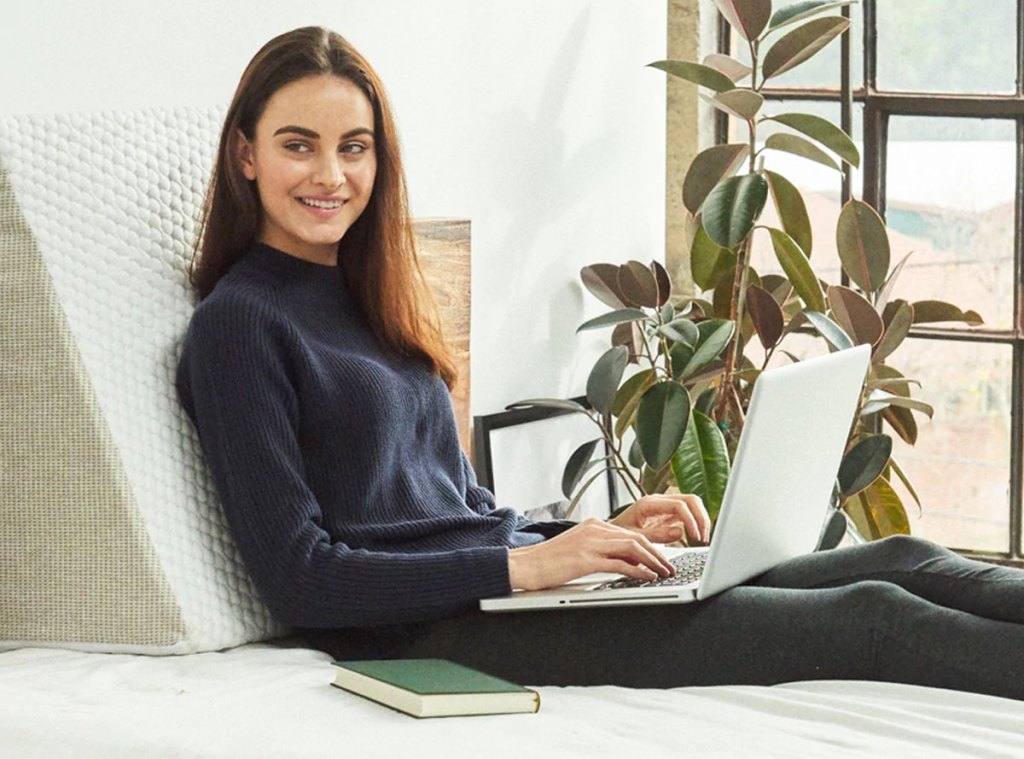 woman leaning against foam wedge pillow