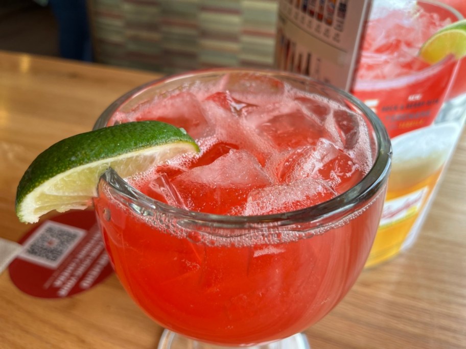 red cocktail with lime on the rim