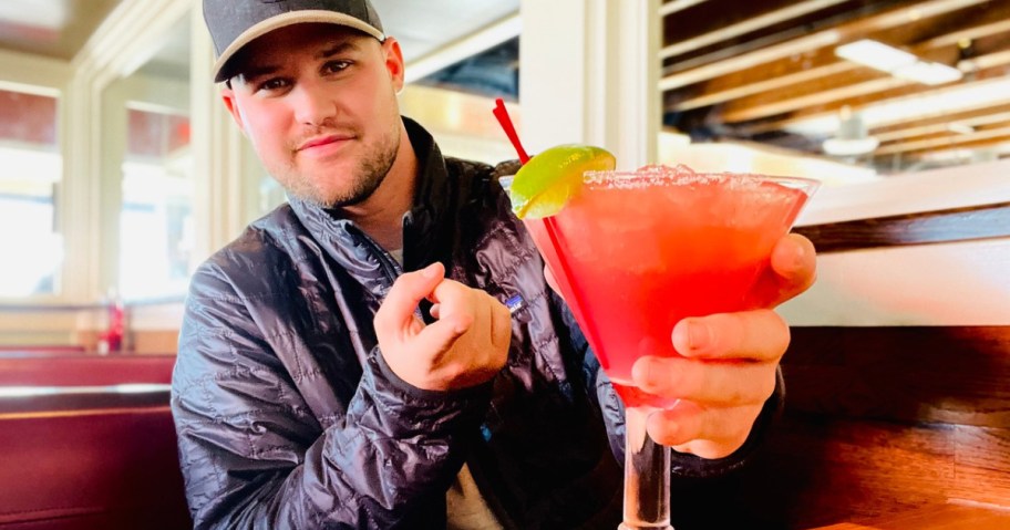 man holding a pink chili's margarita