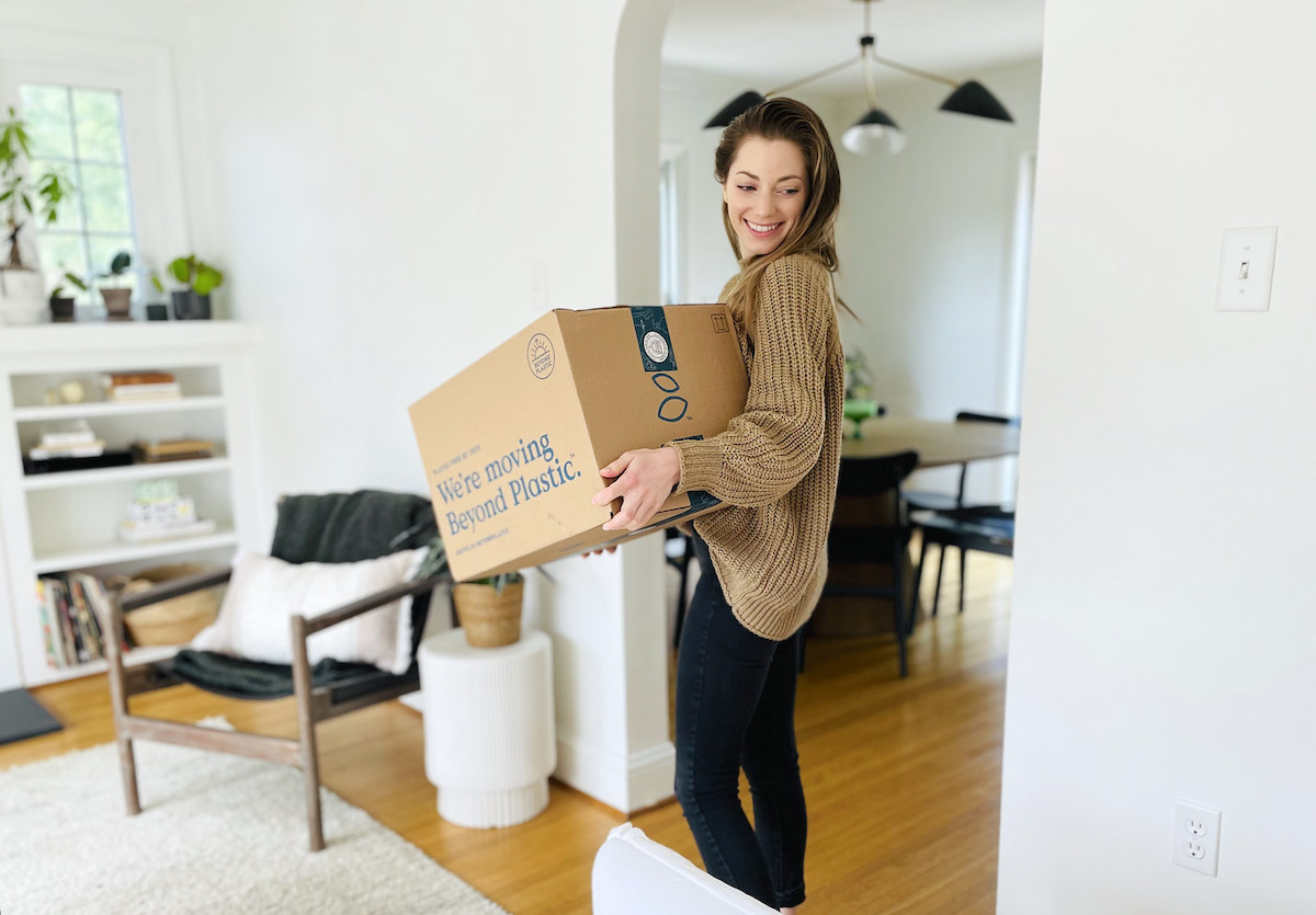 woman smiling holding grove collaborative box