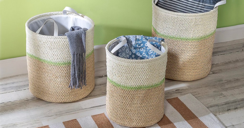 three biege straw baskets with green stripe