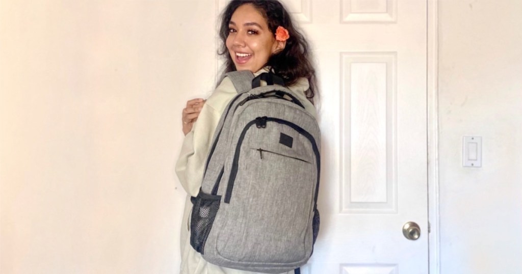 woman holding backpack