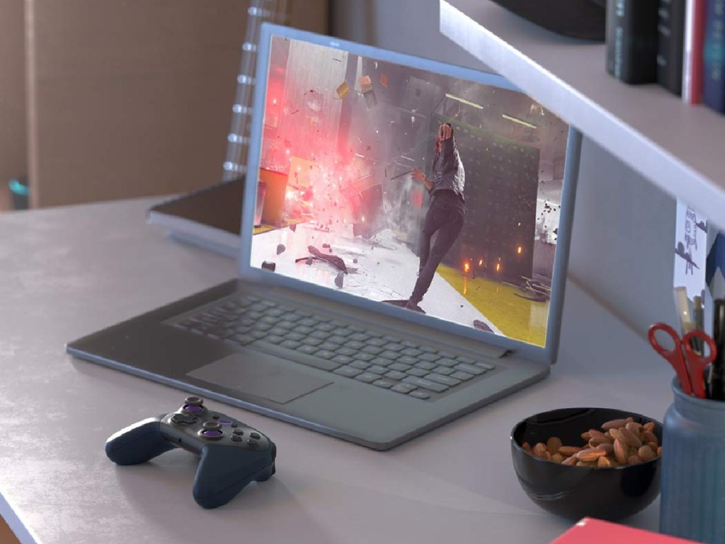 laptop and gaming controller on desk