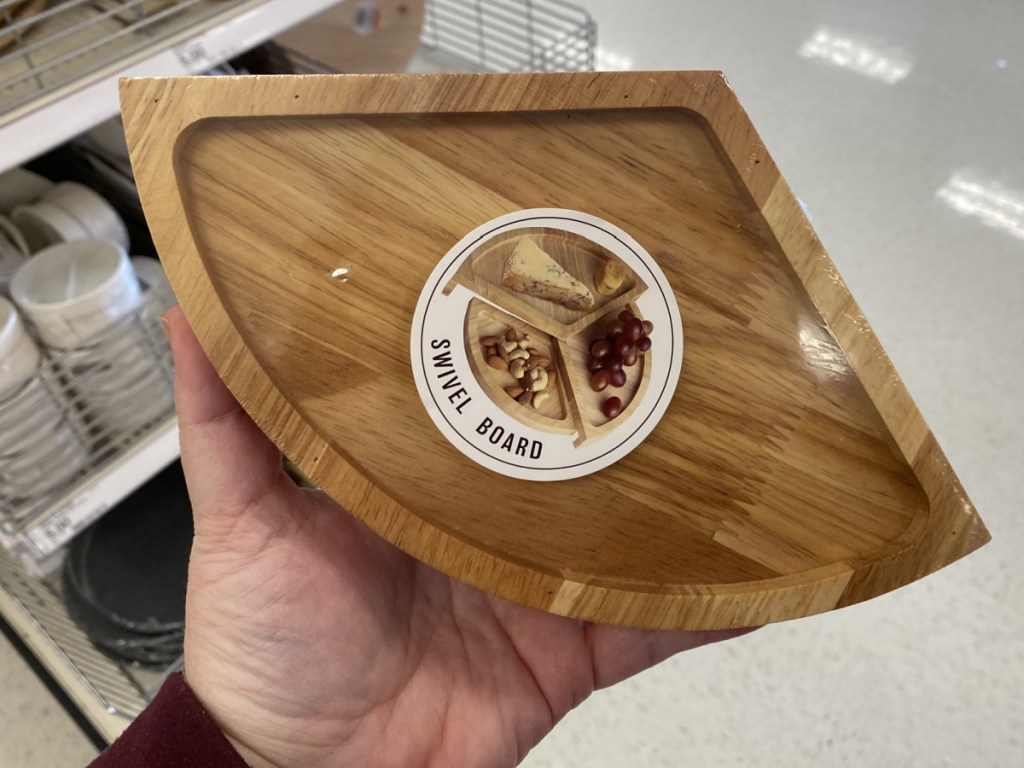 hand holding wooden serving dwivel tray in store