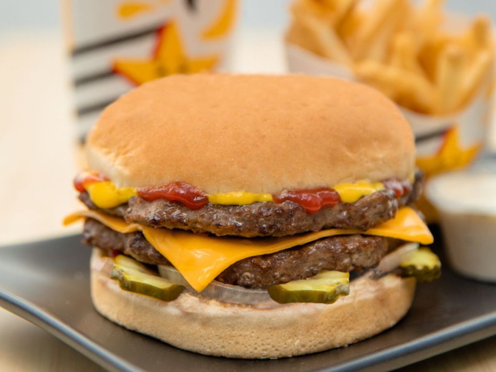 Carl's jr. Double Cheeseburger in front of a drink and fries