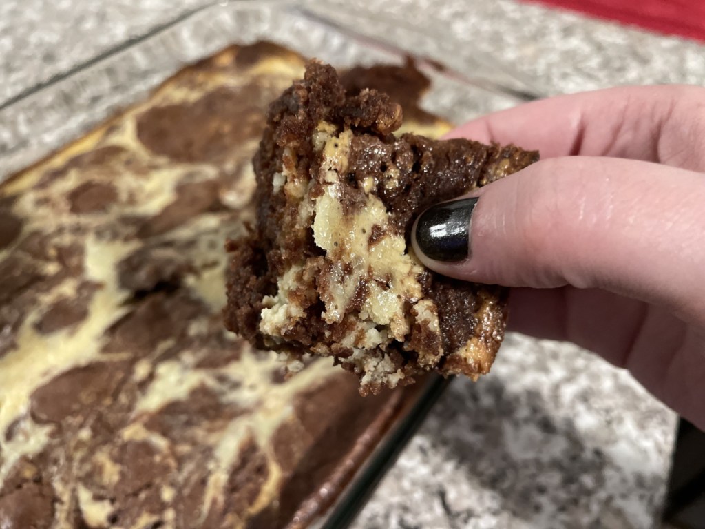 holding a cream cheese brownie