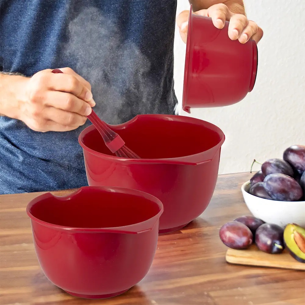 man adding mix to Glad Mixing Bowls set