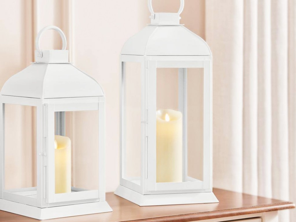 two white metal lantern candle holders