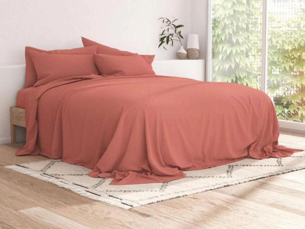 Coral sheets on bed in bedroom