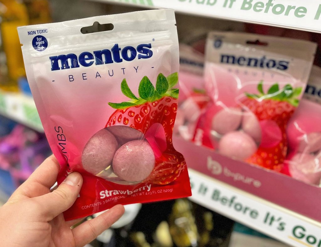 holding up pack of Mentos Bath Bombs
