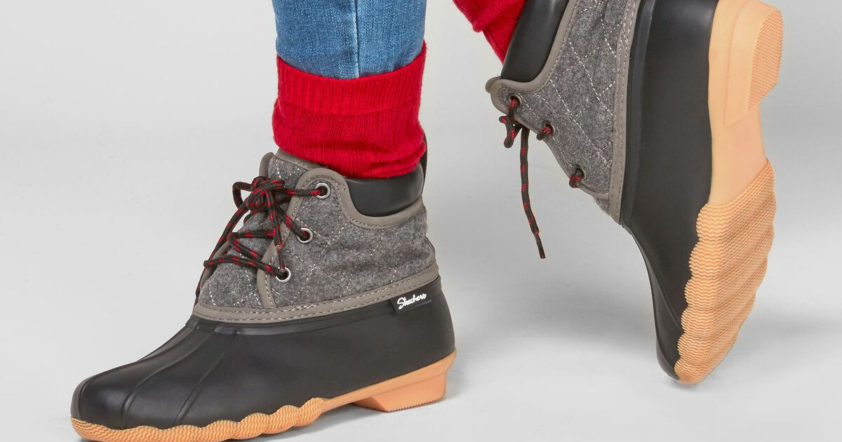 woman's feet in gray and black duck boots