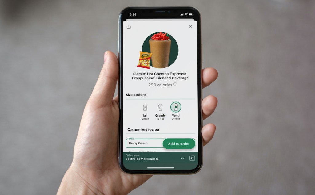 hand holding a phone with starbucks flamin hot cheetos frapp order on screen