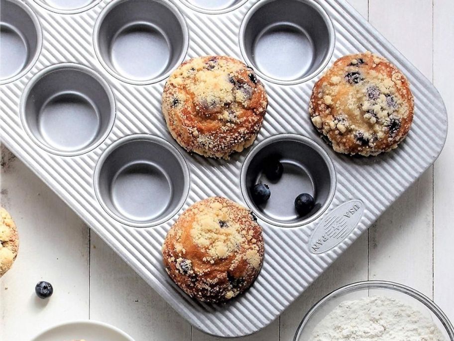 A USA Pan Bakeware Muffin Pan filled with Blueberry Muffins