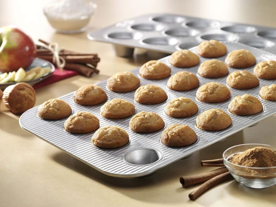 A USA Pan Bakeware Mini Cupcake & Muffin Pan filled with mini muffins