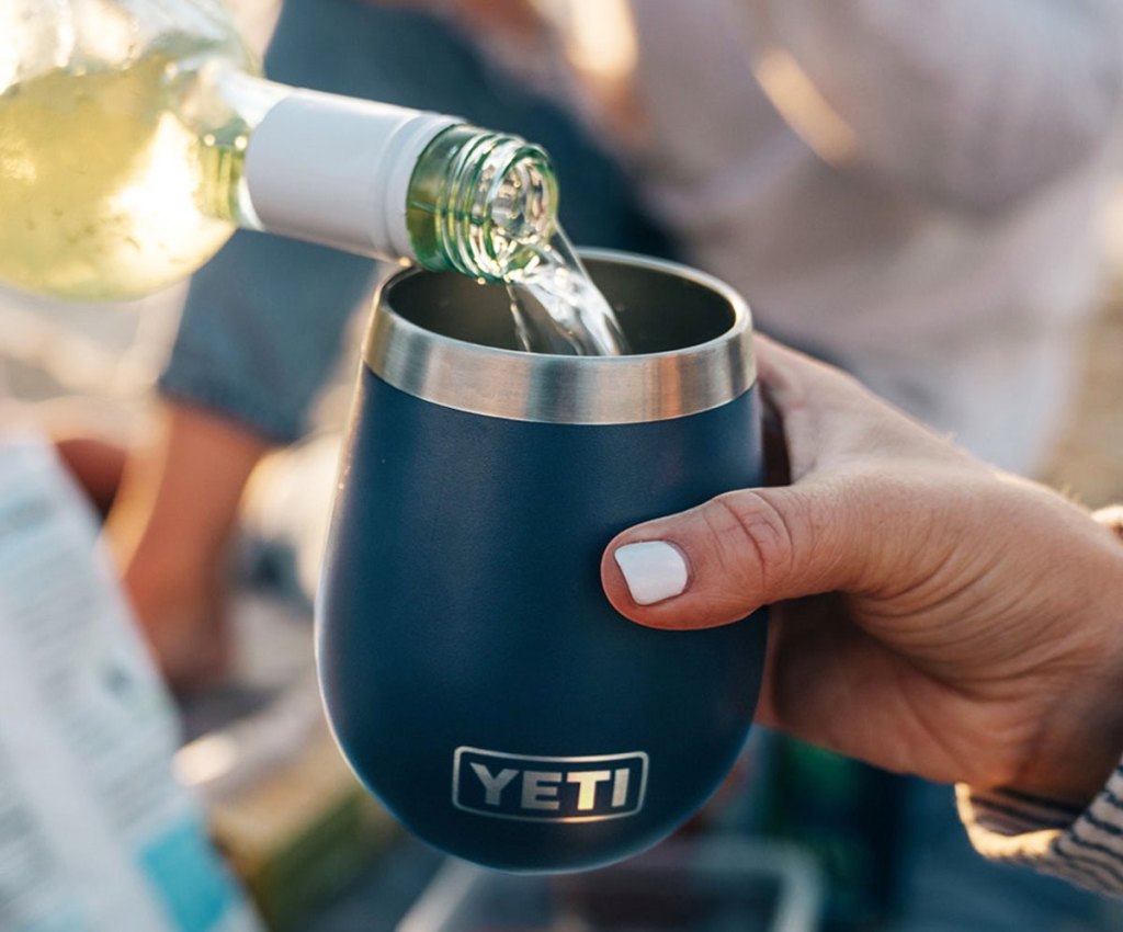 pouring wine into blue yeti wine tumbler