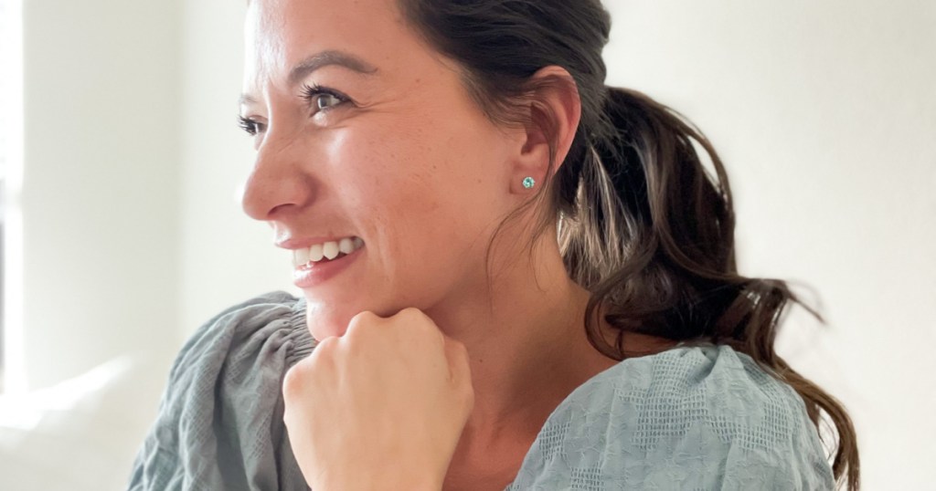 woman wearing blue stud earrings