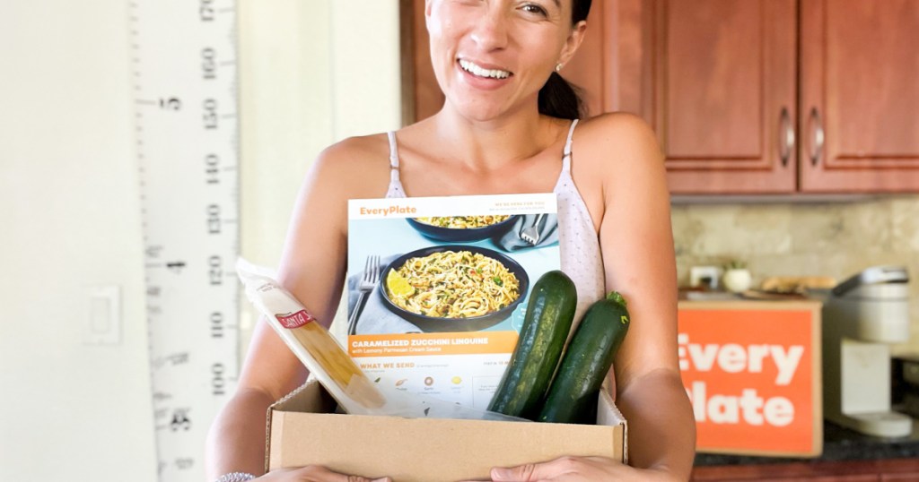 woman holding food in box