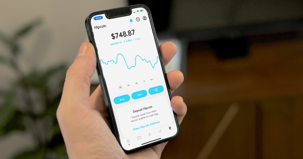 hand holding a phone with hipcoin cryptocurrency on screen