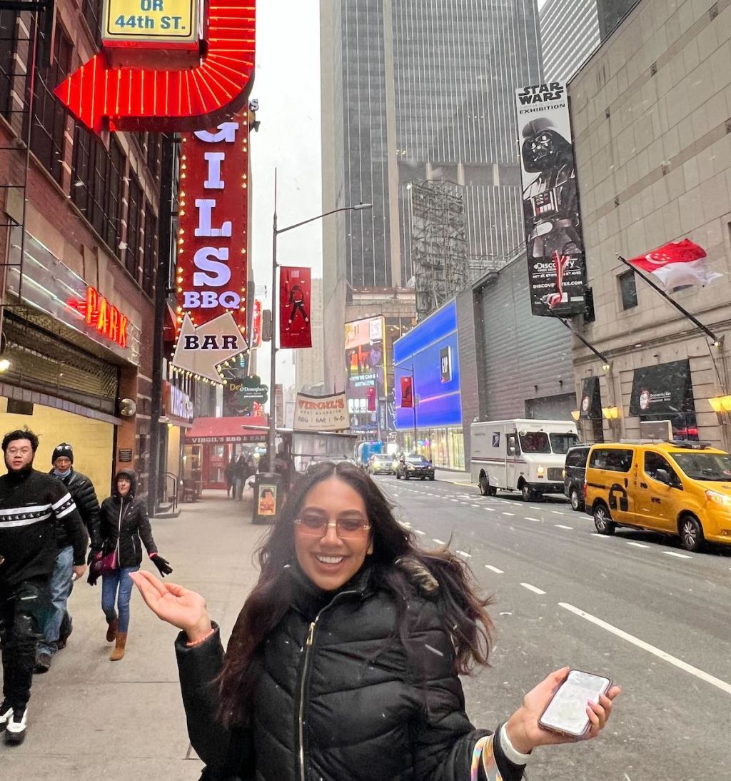 woman standing on new york street with sunglasses and black jacket